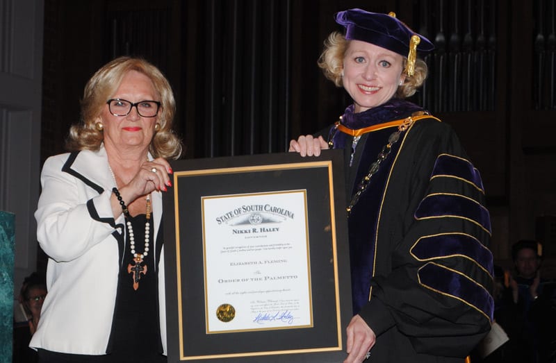 Representative Rita Allison presents the Order of the Palmetto to Betsy Fleming