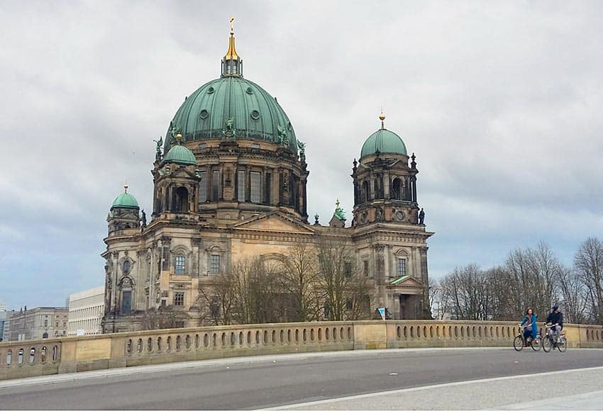 Bicyclists in front of a church
