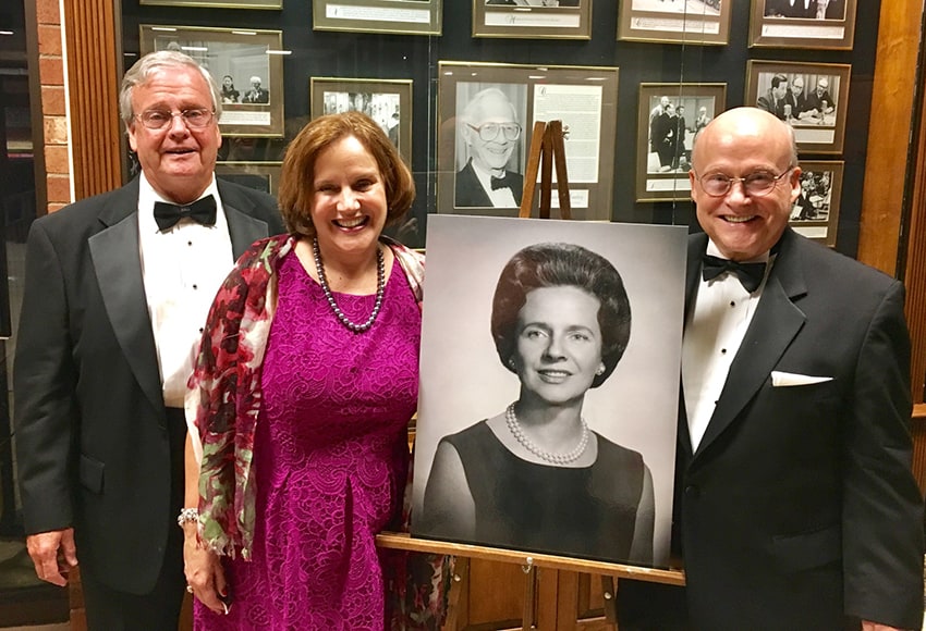 From left: William (Billy) Cribb, Evelyn Cribb Ritchie, and Kenneth (Kenny) Cribb at the inaugural "Dress Up for Dicksie" concert, holding a photo of their mother, Dicksie Brown Cribb
