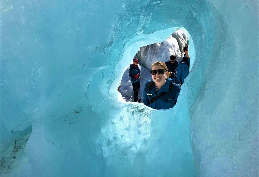 Stephanie stands behind a glacier in New Zealand