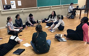 Students discuss their research and collaborate to create the production
