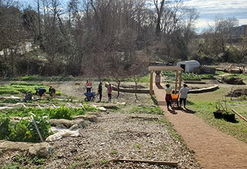 Converse students mulch radish beds at Annie's House