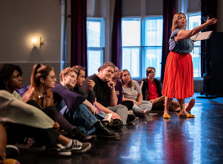 A faculty member teaches a dance class.
