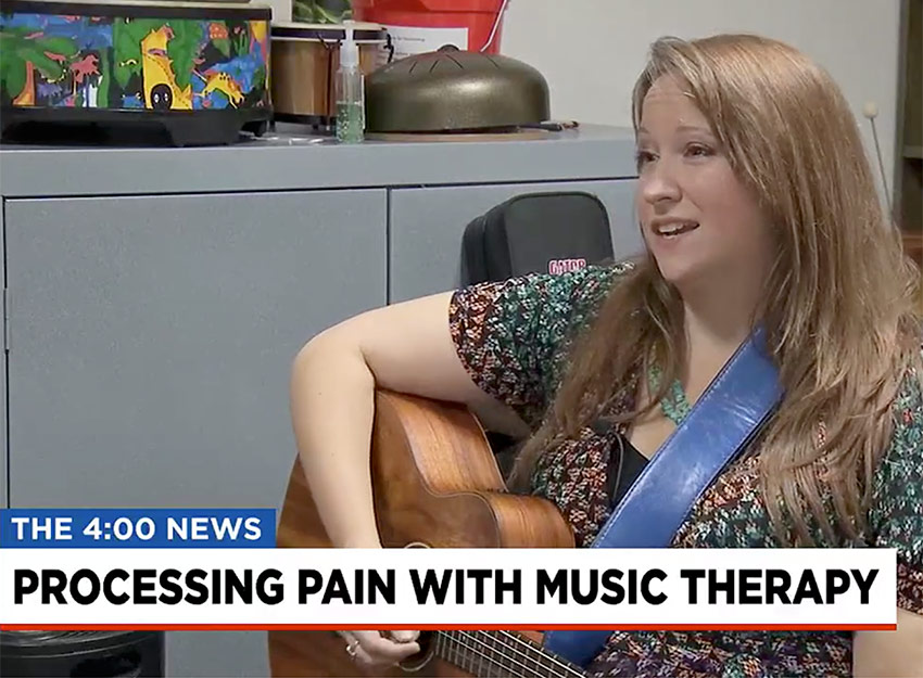 Screenshow from FOX Carolina broadcast of Alison Hughey playing the guitar.