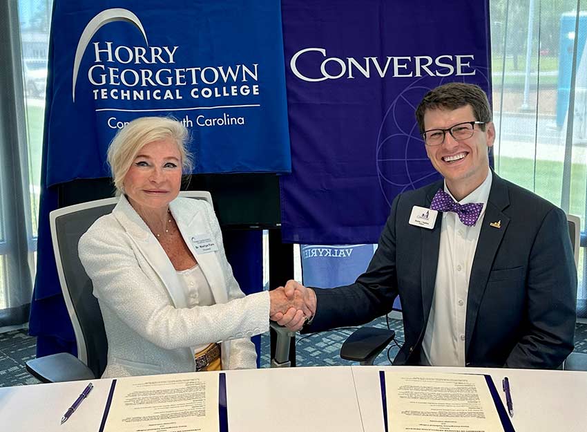 Marilyn Murphy Fore, HGTC President, and Dr. Boone Hopkins, Converse University President, shake hands during the signing of the agreement.