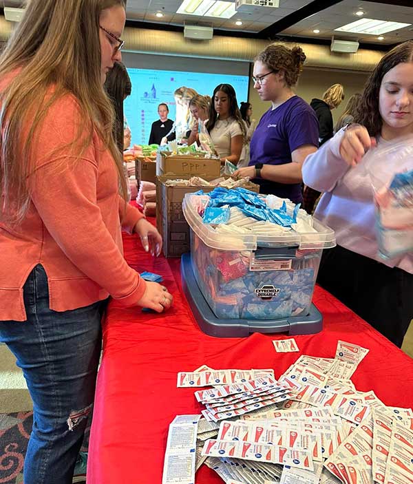 Converse CCW students pack period packs to donate to women in need.