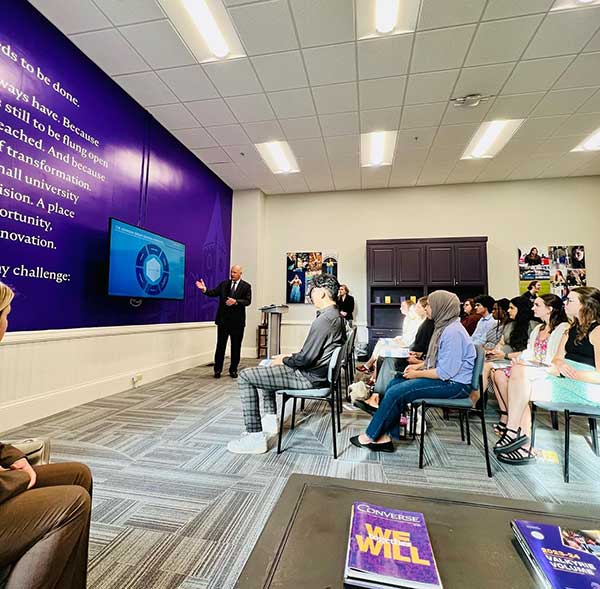 A group of Converse College for Women students watch a presentation from the Johnson Group.