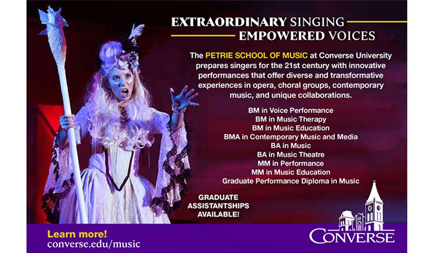 A woman in a costume sings onstage with dramatic lighting
