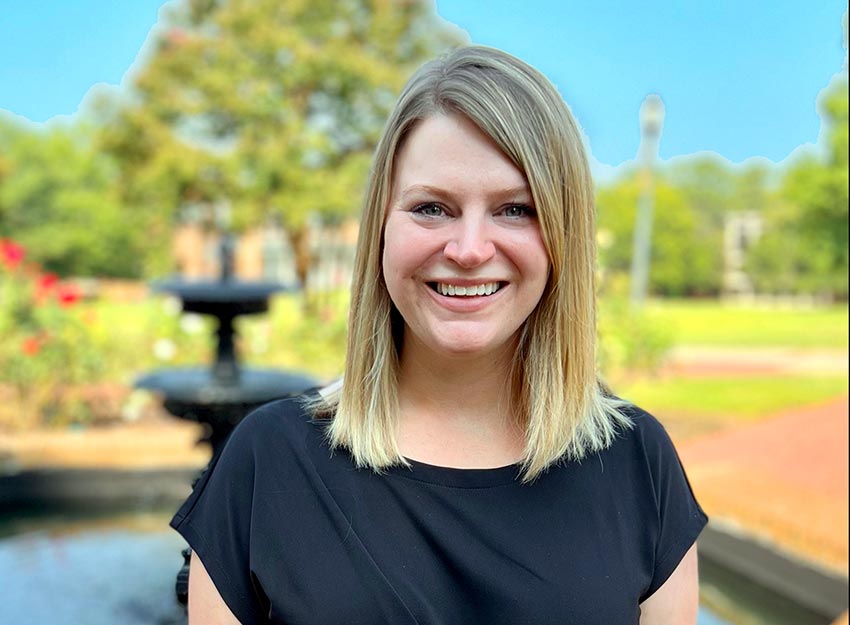 Converse Alumni Association President for 2024-2025, Valerie Dowling, stands in front of a fountain on campus.
