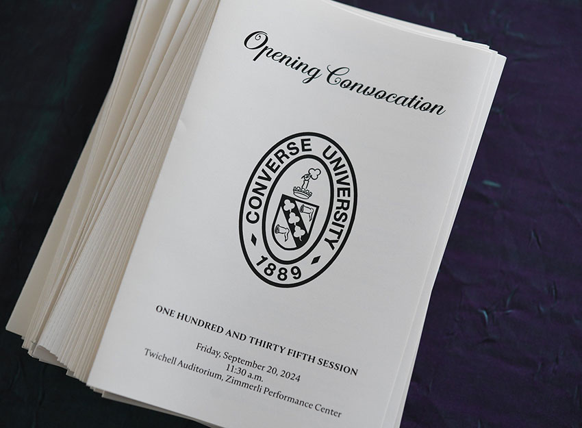 Multiple copies of the convocation program with the Converse seal and the text 'Friday September 20, 2024; 135th session, Converse University."