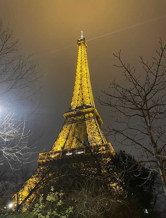 View of the Eiffel Tower in Paris from below in the evening