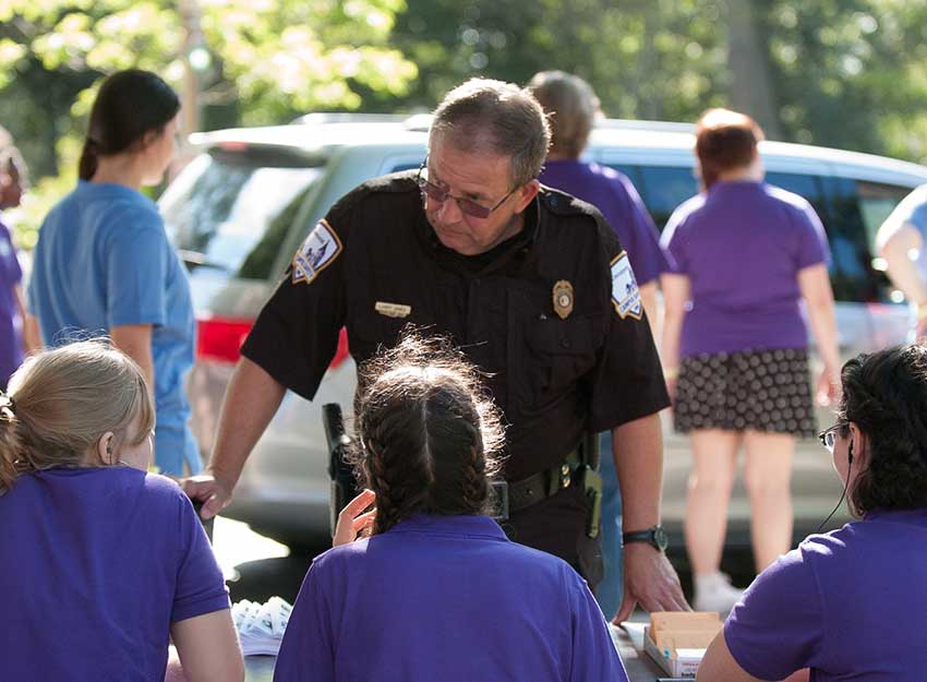 Campus safety Director Larry Jones speaks to Converse students during move-in day.