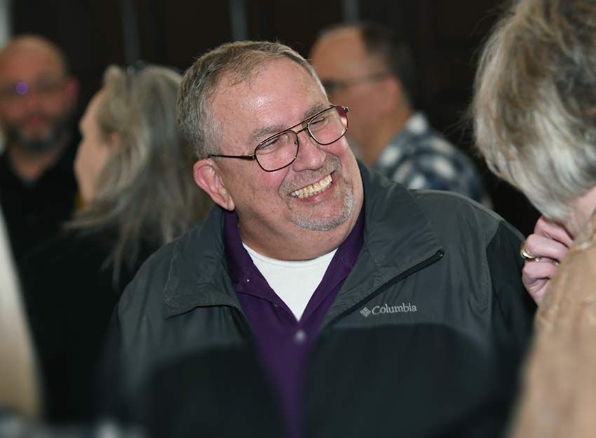 Larry Jones laughs while having a conversation at his retirement party.
