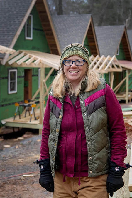 Amy Cantrell stands outside some houses she is helping to build.