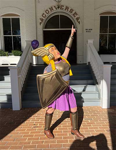 The character of Val stands in front of Converse's Wilson Hall.